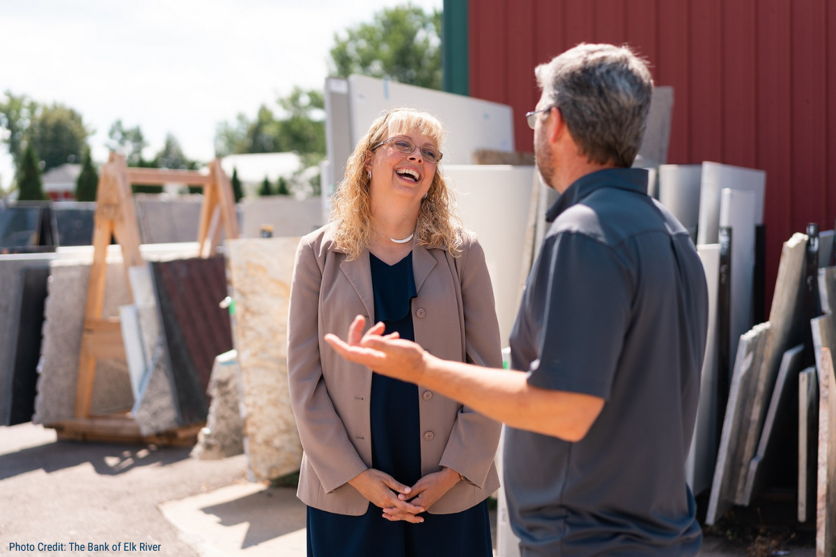 Community banker speaking with a small business owner at a Minnesota stone and landscaping supply yard.
